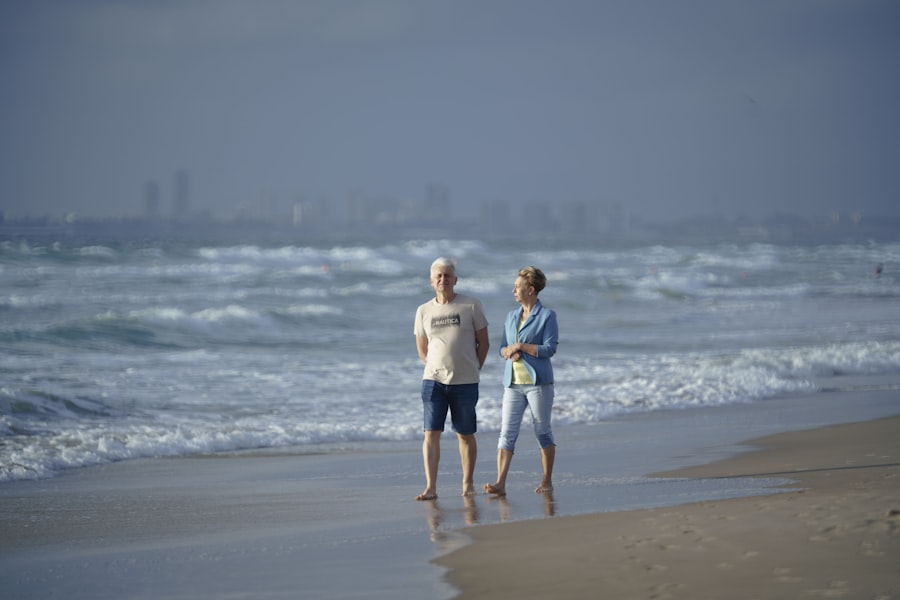 An older couple standing together on a beach