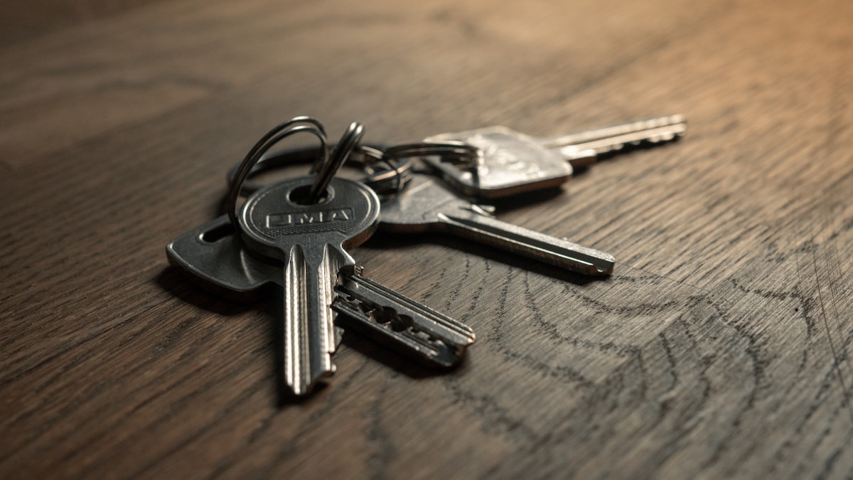 A set of keys resting on a wooden table